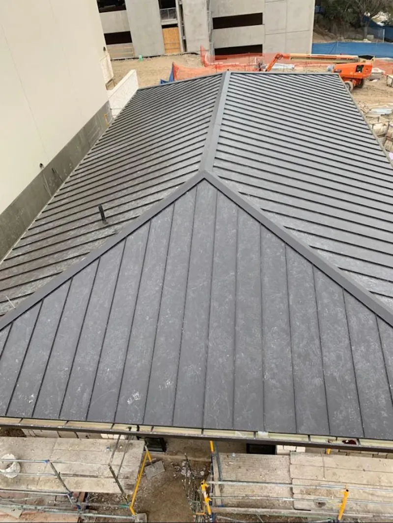 Commercial metal roof construction with crane equipment in CaÃ±on City